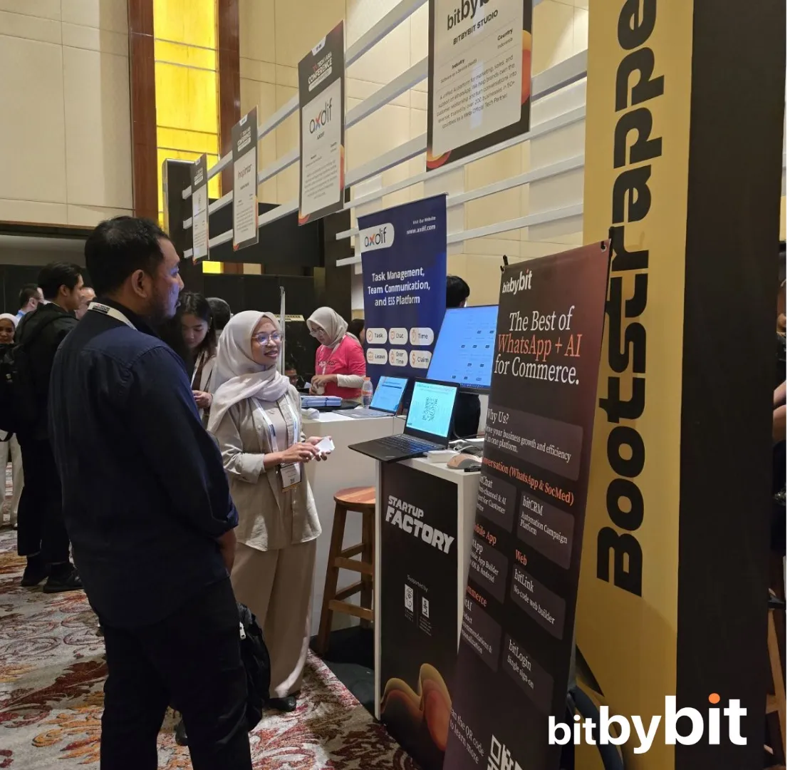 Visitors at the bitbybit booth at Tech in Asia 2025, with product displays for the Bootstrap track