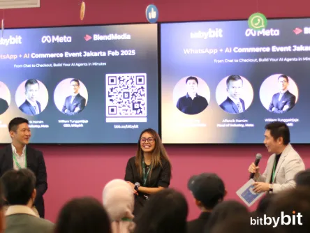 Host with microphone on stage at the WhatsApp + AI Commerce Event Jakarta, February 2025, with panel slides behind